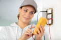 female electrician testing wall socket Royalty Free Stock Photo