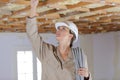 female electrician wiring inside ceiling Royalty Free Stock Photo