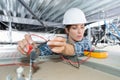 female electrician working on ceiling cables Royalty Free Stock Photo