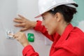 female electrician working on wall socket Royalty Free Stock Photo