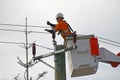 Female electricity worker fixing power line Royalty Free Stock Photo