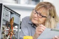 female electronic engineer reading computer results Royalty Free Stock Photo