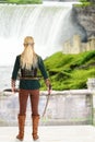 Female elf with sword looking at waterfall Royalty Free Stock Photo