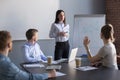 Female employee asking question to business speaker during metin Royalty Free Stock Photo