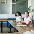 Female employee discuss with colleague at meeting Royalty Free Stock Photo