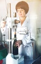 Female employee using machine to cork wine Royalty Free Stock Photo