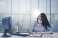 Female employee writing on the paperwork