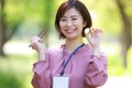 Female employee with 500 yen coin and chopsticks Royalty Free Stock Photo