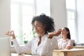 Female employees meditating in mudra position in office Royalty Free Stock Photo