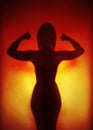 Female empowerment concept silhouette of a strong woman flexing muscles Royalty Free Stock Photo