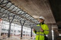 Female engineer checking building documentation on clipboard at construction site. Royalty Free Stock Photo
