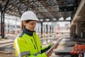 Female engineer checking building documentation on clipboard at construction site. Royalty Free Stock Photo