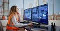 Female Engineer Checking Efficiency On Multiple Screens Royalty Free Stock Photo