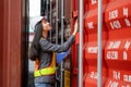 Female engineer with clipboard inspecting containers box, Foreman worker checking containers box at shipping container yard Royalty Free Stock Photo