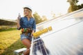 Female engineer developing project on installation of solar panels outdoors Royalty Free Stock Photo