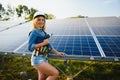 Female engineer developing project on installation of solar panels outdoors Royalty Free Stock Photo