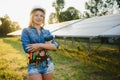 Female engineer developing project on installation of solar panels outdoors Royalty Free Stock Photo