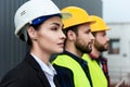 female engineer and male workers in helmets