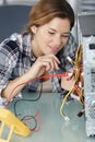 female engineer testing computer with multimeter Royalty Free Stock Photo
