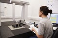 Female Engineer Uses CMM Coordinate Measuring Machine In Factory