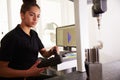 Female Engineer Using CAD System To Work On Component