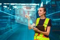 Female engineer using futuristic digital interface in a smart warehouse, illustrating technology, innovation, and industrial Royalty Free Stock Photo