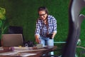 Female engineer working in her office with a cup of coffee in hands. - Image Royalty Free Stock Photo