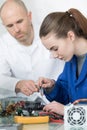 Female engineering student making connections for electronics laboratory experiment