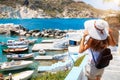 Female enjoys the view to the fishing village of Mandrakia on the island of Milos, Cyclades Royalty Free Stock Photo