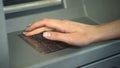 Female entering PIN number to check bank account and withdraw money from ATM Royalty Free Stock Photo