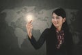 Female entrepreneur holding a bright bulb