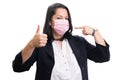 Female entrepreneur pointing at mask making thumb up gesture Royalty Free Stock Photo