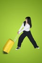 Female entrepreneur pulls a heavy luggage Royalty Free Stock Photo