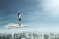 Female entrepreneur stands on paper plane Royalty Free Stock Photo