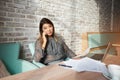 Female entrepreneur talking on mobile phone during work on laptop c Royalty Free Stock Photo