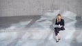 Female entrepreneur using laptop outside concrete building