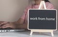 Female entrepreneur working sitting at a desk typing on her laptop computer in a home office Royalty Free Stock Photo