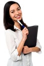 Female executive holding business file and pen Royalty Free Stock Photo