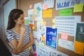 Female executive looking at bulletin board