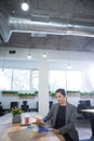 Female executive looking at documents at desk