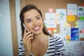 Female executive talking on mobile phone in office Royalty Free Stock Photo