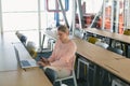 Female executive using laptop while holding mobile phone in the conference room Royalty Free Stock Photo