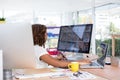 Female executive working over graphic tablet at her desk Royalty Free Stock Photo