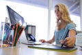 Female executive working over graphic tablet at her desk Royalty Free Stock Photo