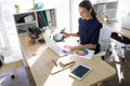 Female executive working over graphic tablet at her desk Royalty Free Stock Photo