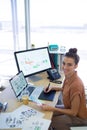 Female executive working over graphic tablet at her desk Royalty Free Stock Photo