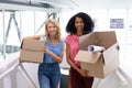 Female executives standing with cardboard boxes in office Royalty Free Stock Photo