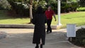 A female exhibitionist runs off in the park