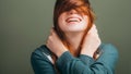 Female expressing joy toothy smile messing hair