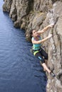 Female extreme climber conquers steep rock Royalty Free Stock Photo